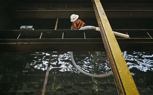 August 23, 2022 Chatsworth - Ethan Brooks removes granular activated carbon from one of several filtration pools used to purify water at the Bruce Hamler Water Treatment Facility in Rome on Tuesday, August 23, 2022. The GAC has to be periodically replaced to effectively remove contaminants from the city’s water supply. (Hyosub Shin / Hyosub.Shin@ajc.com)