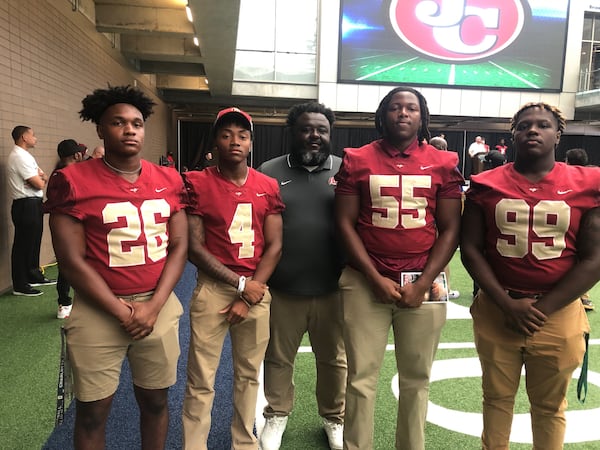 Creekside coach Maurice Dixon (center) is surrounded by his top players on the 2022 teams: Javeon Miller (26), Daiquan White (4), B.J. Williams (55) and Malik Tullis (99). (Photo by Stan Awtrey)