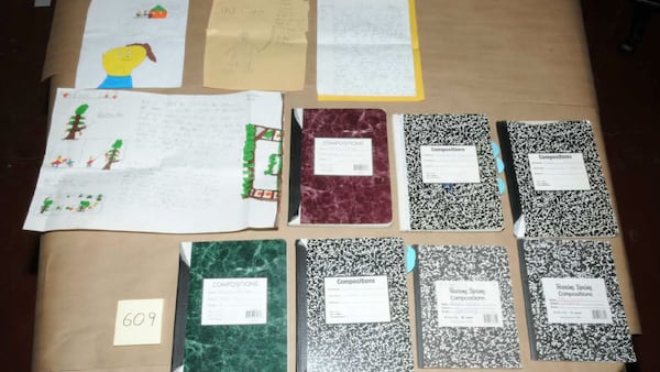 Pictured are some of the journals and other documents seized from the home where Adam Lanza, 20, killed his mother, Nancy Lanza, on Dec. 14, 2012, before committing the Sandy Hook Elementary School massacre. Documents from the investigation into the Sandy Hook shooting are shedding light on Adam Lanza’s anger, scorn for other people and deep social isolation in the years leading up to the school shooting. He killed 20 children and six educators in the shooting before killing himself.