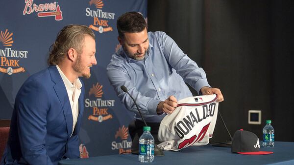 Atlanta Braves general manager Alex Anthopoulos (right) shows Josh Donaldson his new jersey during a press conference Tuesday, Nov. 27, 2018, in Atlanta.