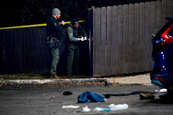 Atlanta police collect evidence as they investigate a shooting that left three people injured Wednesday evening.