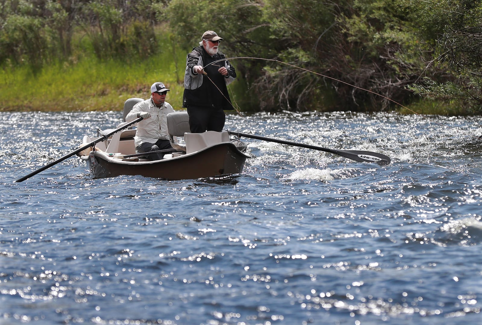 AJC writer Steve Hummer fishes for trout with guide Troy Buhr during a joint float trip with former Falcons quarterback Steve Bartkowski down the Big Hole River.  Curtis Compton/ccompton@ajc.com