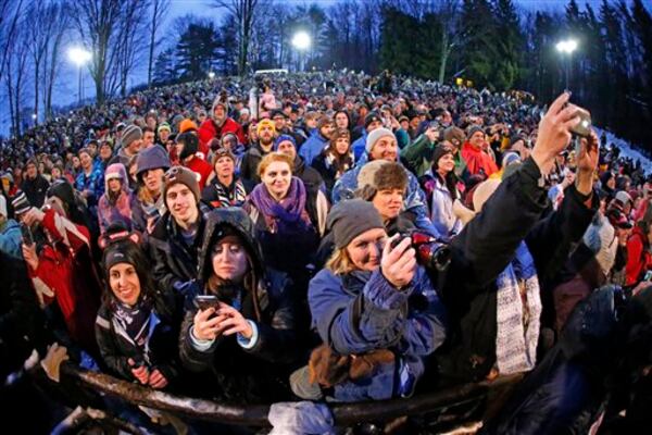 The coronavirus is preventing thousands from gathering in Pennsylvania this year to see Punxsutawney Phil, the weather prognosticating groundhog. Police estimated 11,000 gathered in 2015 when this photo was taken.