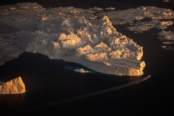 FILE - A ship sails alongside a large iceberg in Ilulissat, Greenland, Feb. 18, 2025. (AP Photo/Emilio Morenatti, File)