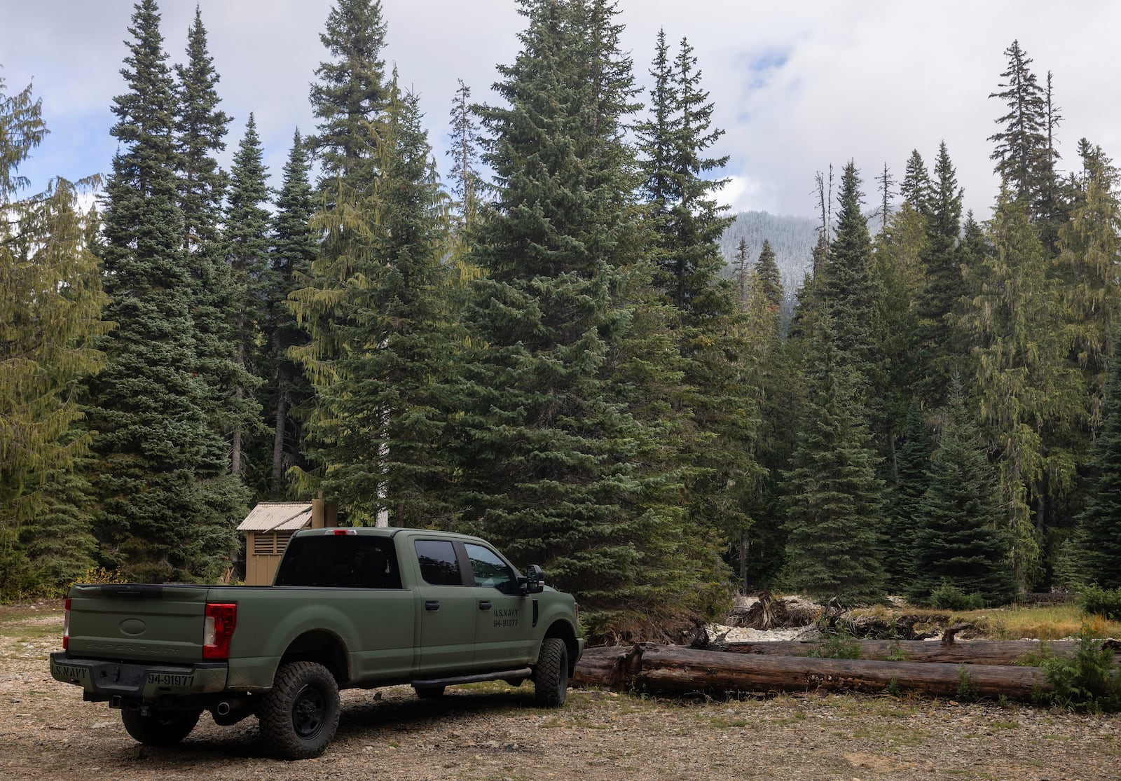 A U.S. Navy pickup truck is seen in a parking lot near Pear Butte, Yakima County, on Thursday, Oct. 17, 2024, as the search continues for two fighter pilots whose EA-18G Growler jet crashed east of Mount Rainier, Wash. (Nick Wagner/The Seattle Times via AP)