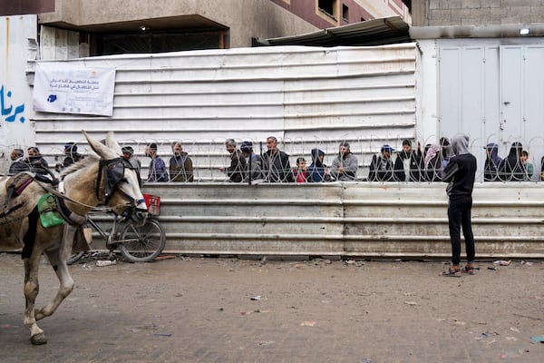 Palestinians queue to purchase bread outside a bakery in Gaza City, Monday, Feb. 24, 2025. (AP Photo/Abdel Kareem Hana)