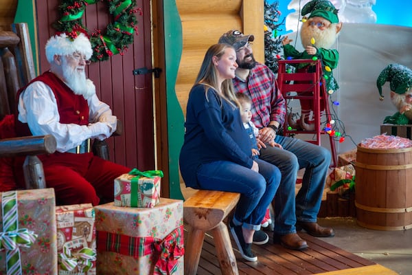 Jason and Kiley Lanahan pose with Santa with their daughter walker at the Bass Pro Shops near Lawrenceville on Saturday, November 13, 2021. STEVE SCHAEFER FOR THE ATLANTA JOURNAL-CONSTITUTION