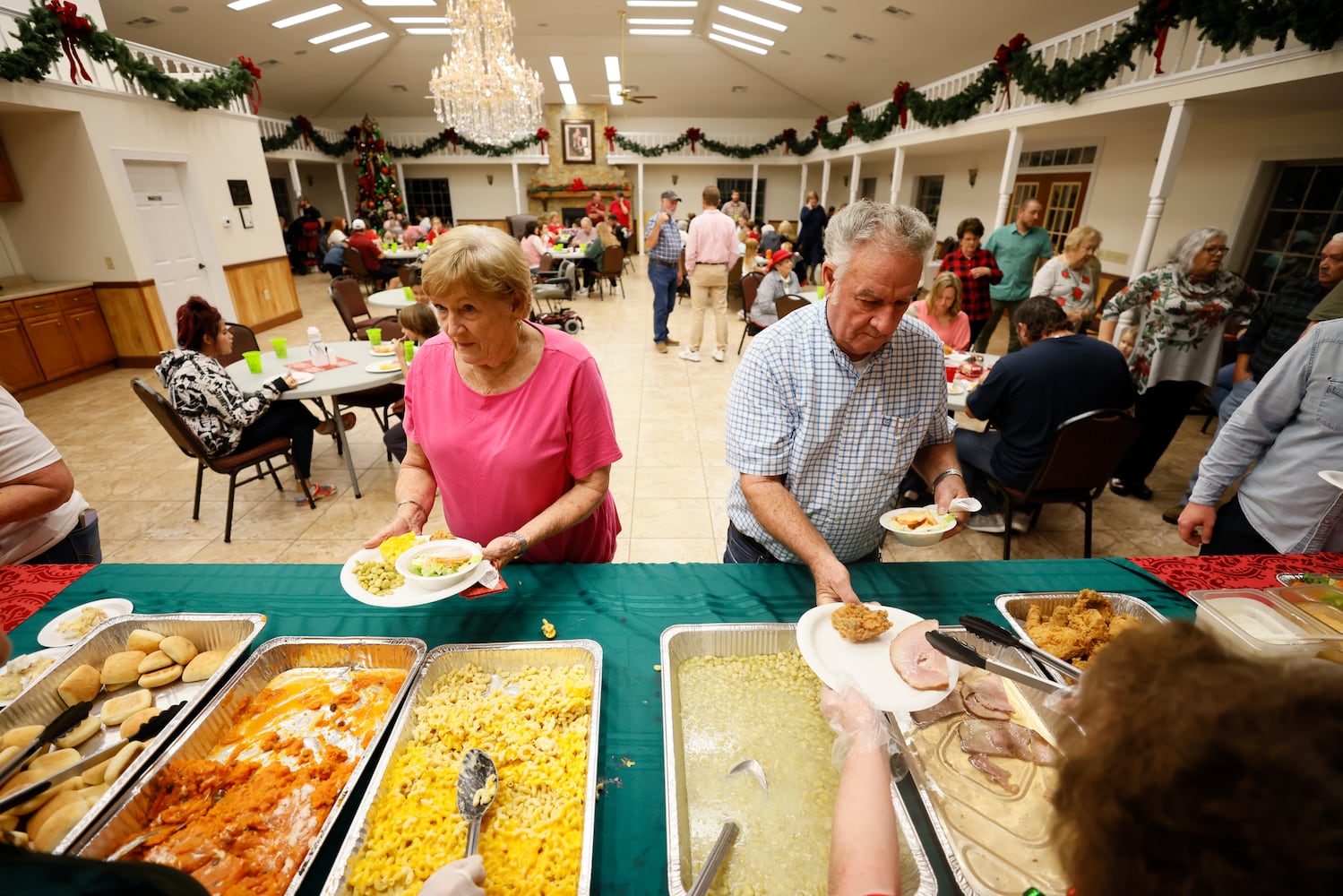 City manager Eddie Wright gets a meal together with his wife, Elaine Wright, during a sit-down Christmas dinner that's free to the community's 204 residents.
 Miguel Martinez / miguel.martinezjimenez@ajc.com