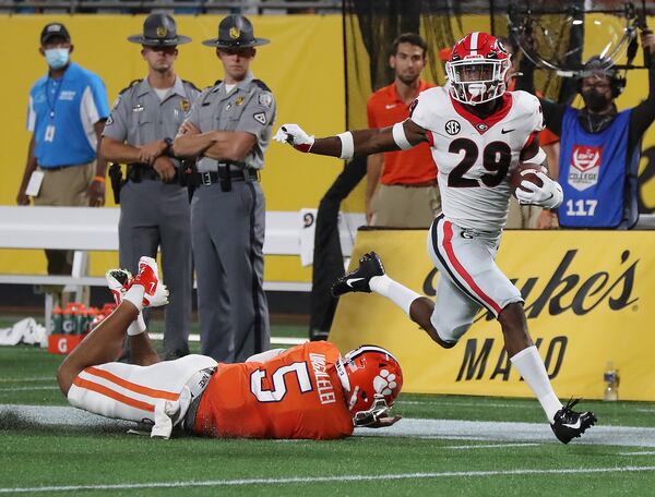 Clemson quarterback D.J. Uiagalelei is the last person to attempt a tackle as Georgia defensive back Christopher Smith intercepts a pass intended for Clemson wide reciever Justyn Ross and returns it for a touchdown during the second quarter Saturday, Sept 4, 2021, in Charlotte, N.C. (Curtis Compton / Curtis.Compton@ajc.com)