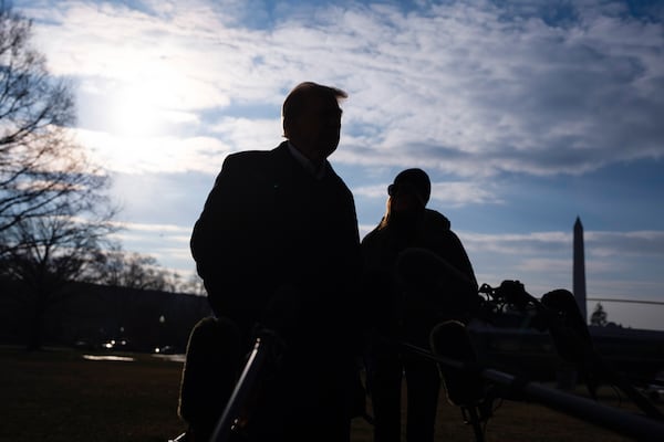 First lady Melania Trump looks on as President Donald Trump speaks with reporters before boarding Marine One on the South Lawn of the White House, Friday, Jan. 24, 2025, in Washington. The Washington Monument stands right. (AP Photo/Evan Vucci)