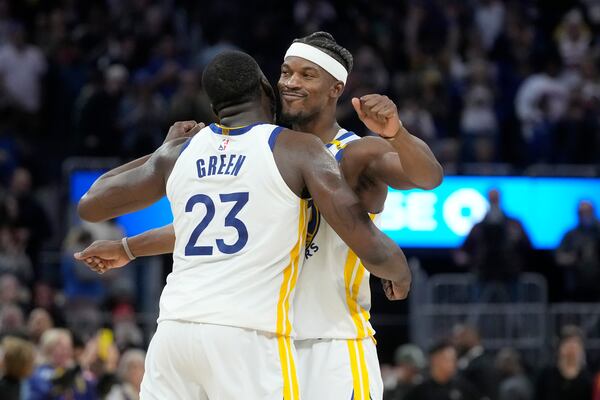 Golden State Warriors forward Draymond Green (23) celebrates with forward Jimmy Butler III, right, during the second half of an NBA basketball game against the Detroit Pistons in San Francisco, Saturday, March 8, 2025. (AP Photo/Jeff Chiu)