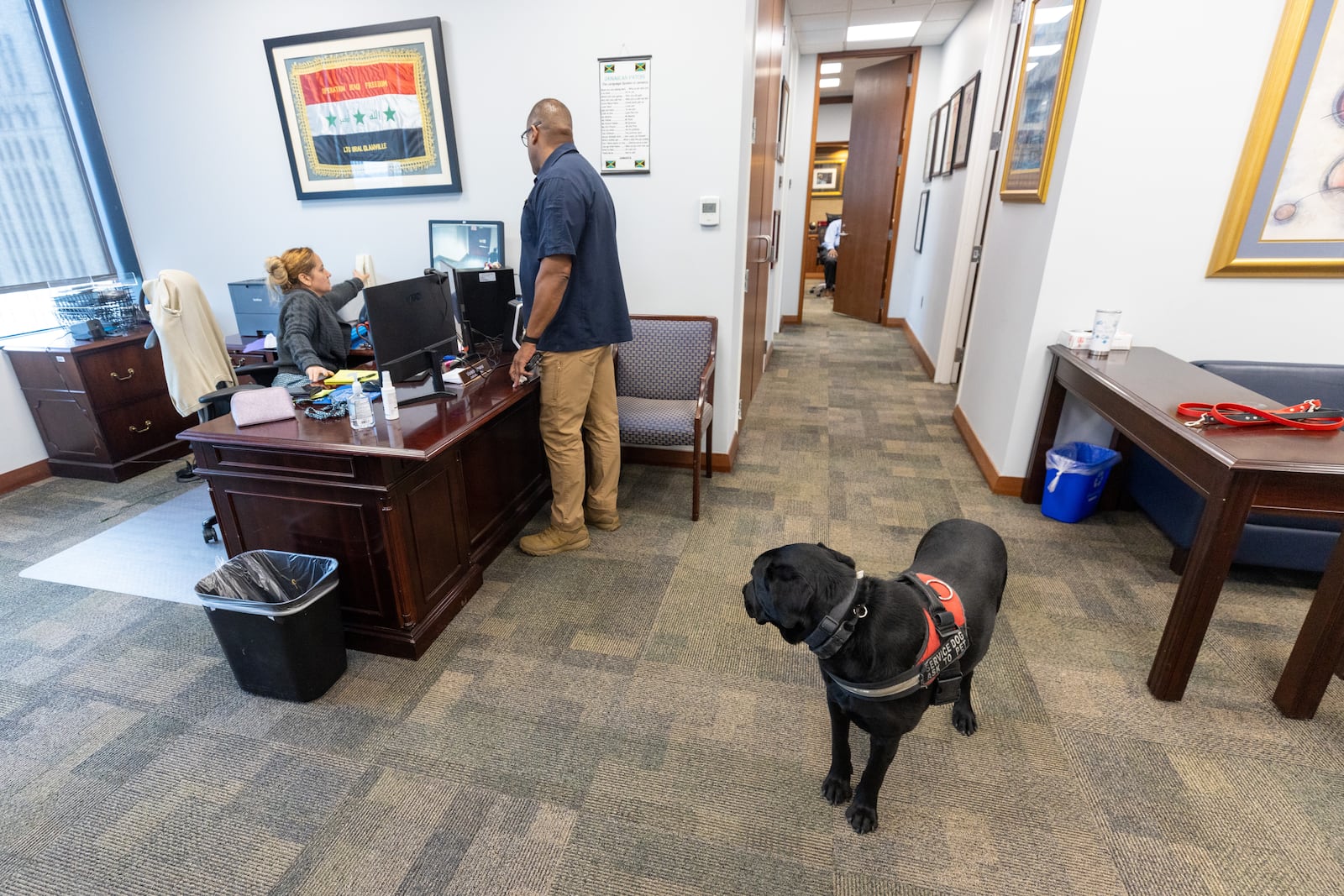 Chief Judge Ural Glanville's service dog, Jack, greets employees in the judge's office on Tuesday, Sept. 26, 2023.  (Steve Schaefer/steve.schaefer@ajc.com)