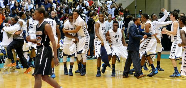 MARCH 8, 2014 MACON Tift County Blue Devils players celebrate after the game. Coverage of the Class AAAAAA boys basketball championship between the Wheeler Wildcats and Tift County Blue Devils at the Macon Coliseum Saturday, March 8, 2014. Tift County Blue Devils beat the Wheeler Wildcats 63-49 for the championship. KENT D. JOHNSON / KDJOHNSON@AJC.COM Tift County players celebrate their Class AAAAAA championship win over Wheeler Saturday, March 8, 2014, in Macon. (Kent D. Johnson / AJC)