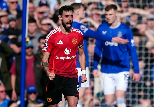 Manchester United's Bruno Fernandes celebrates scoring his side's first goal, during the English Premier League soccer match between Everton and Manchester United, at Goodison Park, in Liverpool, England, Saturday, Feb. 22, 2025. (Peter Byrne/PA via AP)