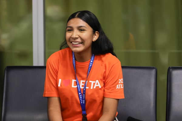 Leslie Santos Vega,15, smiles as she waits to board her first-ever flight on Friday, Sept. 22, 2023. Santos is a part of Delta Air Lines’ ‘Women Inspiring our Next Generation’ (WING) program, which sponsors an all-female charter flight that carries 100 young women interested in aviation from Atlanta to NASA’s Kennedy Space Center in Florida. (Natrice Miller/ Natrice.miller@ajc.com)