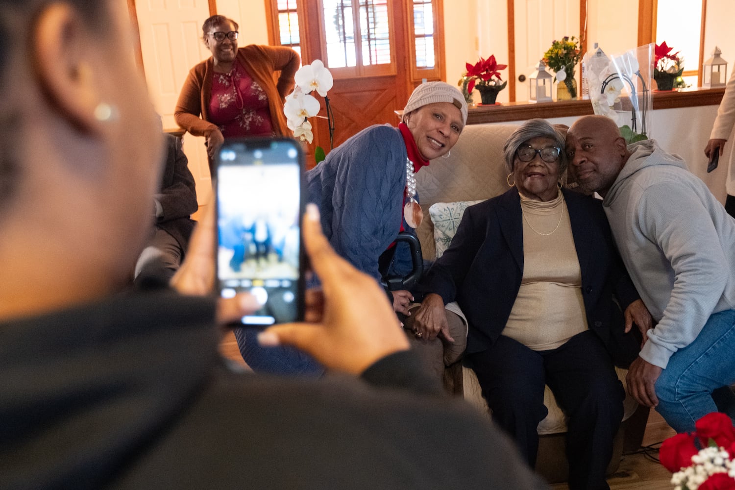 Pastor Norman Roberts Jr. and First Lady Priscilla Roberts pose for a photo with Lillie Mae Hightower during a party for her 102nd birthday in Stockbridge on Friday, Dec. 27, 2024. Roberts is pastor of Antioch Baptist Church in Wrightsville, Ga., where Hightower previously lived. Ben Gray for the Atlanta Journal-Constitution