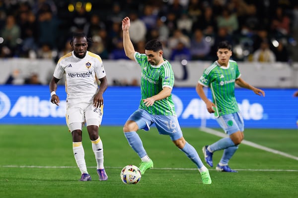 Seattle Sounders midfielder Alex Roldan (16) controls the ball next to Los Angeles Galaxy forward Joseph Paintsil (28) during the second half of an MLS Western Conference final soccer match, Saturday, Nov. 30, 2024, in Carson, Calif. (AP Photo/Etienne Laurent)