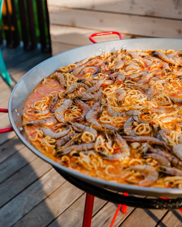 Paella is cooking on the deck at Buena Vida Tapas & Sol. Photo courtesy of Buena Vida Tapas & Sol.