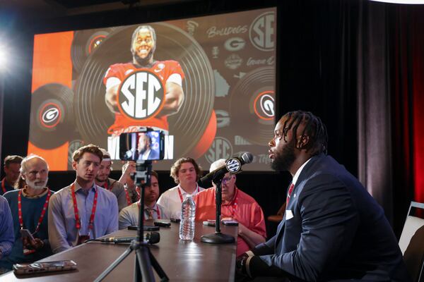 Georgia offensive lineman Sedrick Van Pran speaks as an image of Van Pran is shown in the background during NCAA college football Southeastern Conference Media Days, Tuesday, July 18, 2023, in Nashville, Tenn. (Jason Getz / Jason.Getz@ajc.com)