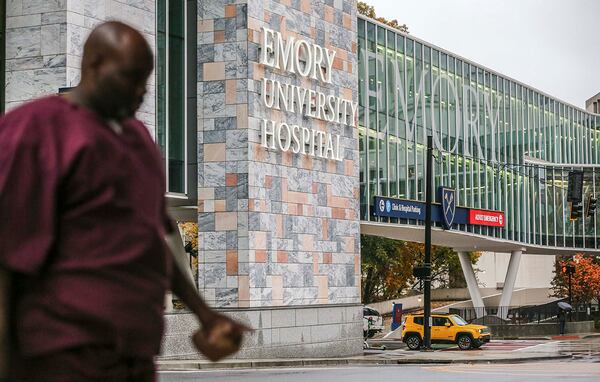 Medical personnel walk the campus at Emory Hospital in November 2019. “The national message is there are millions of these tests out there and the reality is very far from that, at least here in Georgia,” said Dr. Jonathan Lewin, CEO of Emory Healthcare, which operates 10 metro area hospitals. JOHN SPINK/JSPINK@AJC.COM