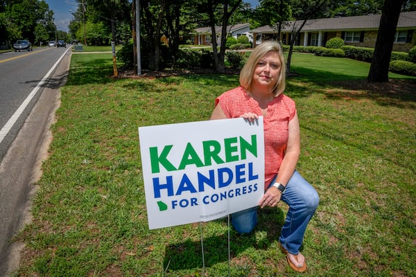 Vikki Thomas is shown with her campaign sign for Karen Handel in her yard, Friday, June 2, 2017, in Roswell, Ga. When a news report came out about Jon Ossoff signs allegedly being stolen on her street, it got her worried about hers’.  (John Amis)