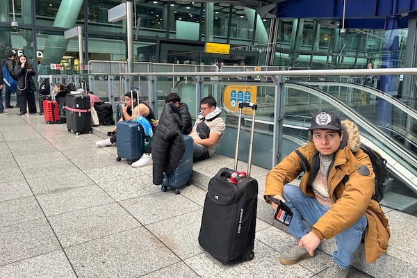 Travellers are waiting as Britain's Heathrow Airport has closed for the full day Friday after an electrical substation fire knocked out its power, disrupting flights for hundreds of thousands of passengers at one of Europe's biggest travel hubs in London, Friday, March 21, 2025.(AP Photo/Kin Cheung)