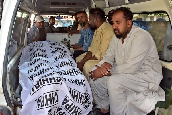 Relatives prepare to transport body of a victim of a bomb explosion at railway station, after receiving from a hospital, in Quetta, southwestern Pakistan, Saturday, Nov. 9, 2024. (AP Photo/Arshad Butt)