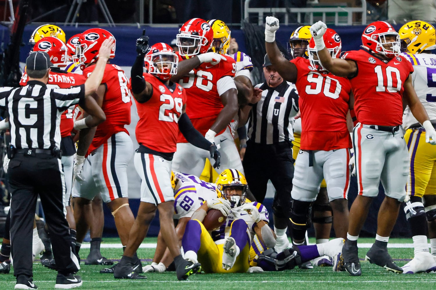 LSU Tigers running back Josh Williams (27) is stopped by Georgia Bulldogs defenders on a fourth down play during the second half of the SEC Championship Game at Mercedes-Benz Stadium in Atlanta on Saturday, Dec. 3, 2022. (Bob Andres / Bob Andres for the Atlanta Constitution)