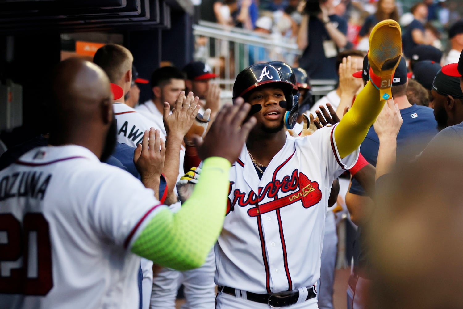 Braves right fielder Ronald Acuna Jr. (13) high-fives teammates at the dugout after scoring a run during the second inning against the Colorado Rockies at Truist Park on Thursday, June 15, 2023, in Atlanta.
Miguel Martinez / miguel.martinezjimenez@ajc.com 