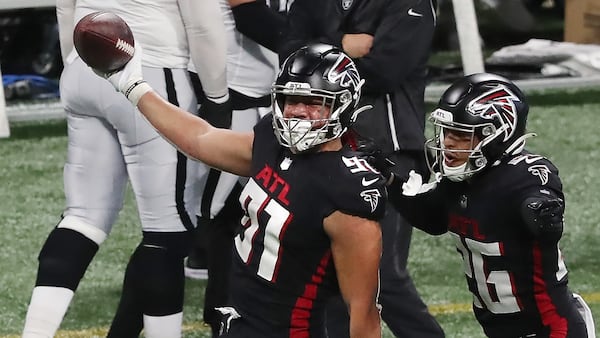 112920 ATLANTA: Atlanta Falcons defensive tackle Jacob Tuioti-Mariner (left) celebrates his strip sack and fumble recovery of Las Vegas Raiders quarterback Derek Carr with Isaiah Oliver during the second quarter Sunday, Nov. 29, 2020, at Mercedes-Benz Stadium in Atlanta. (Curtis Compton / Curtis.Compton@ajc.com)