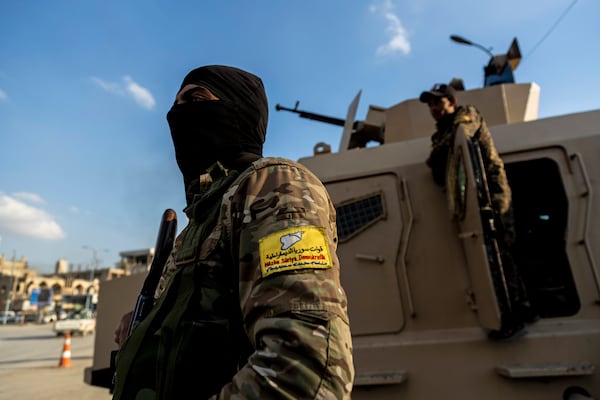 FILE - Kurdish-led fighters backed by the U.S. stand guard in Raqqa, Syria, on Feb. 7, 2022. (AP Photo/Baderkhan Ahmad, File)