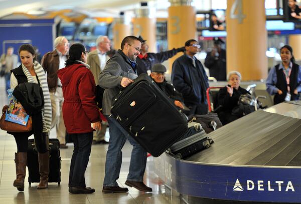 November 18, 2014 Atlanta - Travelers wait at baggage claim area at Hartsfield-Jackson International Airport on Tuesday, November 18, 2014. HYOSUB SHIN / HSHIN@AJC.COM