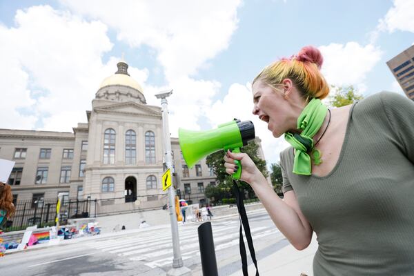 Arguments over Georgia’s new abortion law ban began Monday in Fulton County Superior Court. Pictured is a demonstrator outside the  the Georgia State Capitol, where in July people gathered to protest the reversal of Roe. v. Wade by the U.S. Supreme Court. (Miguel Martinez/AJC)