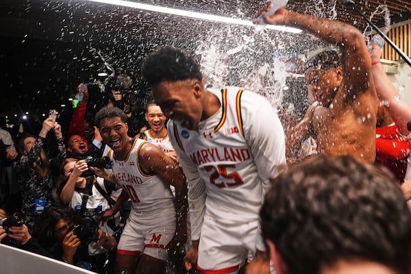 Maryland forward Julian Reese, left, celebrates with teammates, including center Derik Queen (25), who made the winning basket to beat Colorado State 72-71 in the second round of the NCAA college basketball tournament Sunday, March 23, 2025, in Seattle. (AP Photo/Lindsey Wasson)