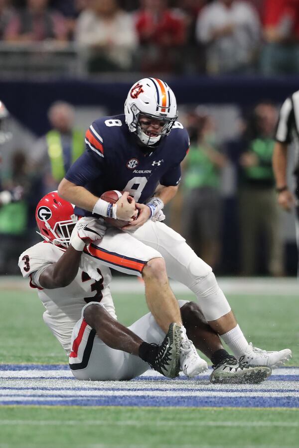 Auburn quarterback Jarrett Stidham is sacked by Georgia linebacker Roquan Smith during the first half of the SEC championship at Mercedes-Benz Stadium.