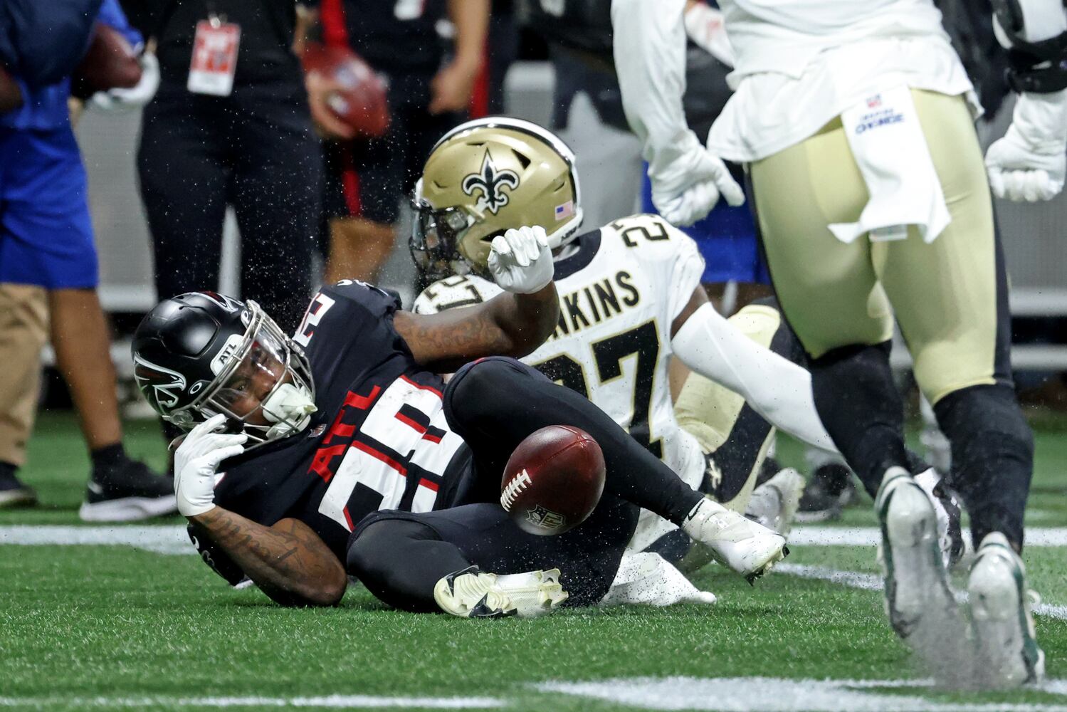 Falcons running back Mike Davis (28) fumbles the ball after being hit by Saints safety Malcolm Jenkins (27) during the second quarter. (JASON GETZ FOR THE ATLANTA JOURNAL-CONSTITUTION)