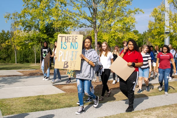 Students walk onto the football field for an organized school-wide climate walkout on Thursday, Sept. 26, 2019, in Atlanta, Georgia. North Atlanta High School, along with other Atlanta Public Schools, walked out on Thursday and Friday, Sept. 27, to call for action against climate change. (Photo/Rebecca Wright for the Atlanta Journal Constitution)