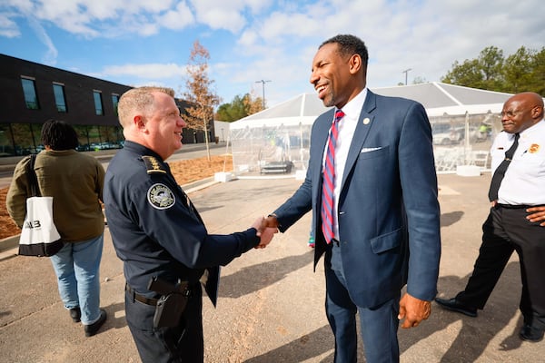 Atlanta Police Chief Darin Schierbaum shakes hands with Atlanta Mayor Andre Dickens at the Atlanta Public Safety Training Center as they prepare for a media tour at the nearly finished controversial site on Dec. 17, 2024. Miguel Martinez/AJC 2024