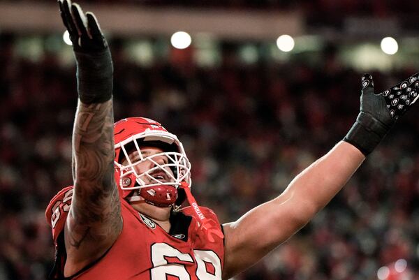 Georgia offensive lineman Tate Ratledge (69) celebrates a Georgia score against Georgia Tech during the sixth overtime of an NCAA college football game, Saturday, Nov. 30, 2024, in Athens, Ga. (AP Photo/Mike Stewart)