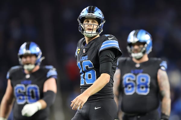 Detroit Lions quarterback Jared Goff (16) reacts on the field in front of guard Graham Glasgow (60) and offensive tackle Taylor Decker (68) during the second half of an NFL football game against the Buffalo Bills, Sunday, Dec. 15, 2024, in Detroit. (AP Photo/Rey Del Rio)