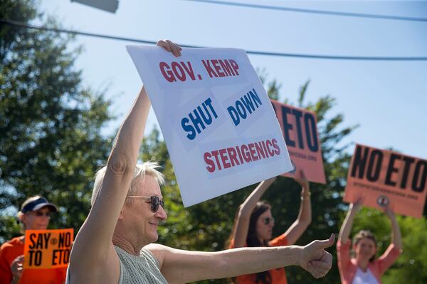 Robin Cubbage of Smyrna gives a thumbs-up to a passer-by during a protest against a Cobb County Sterigenics plant at the intersection of Atlanta Road and Plant Atkinson Road. (Alyssa Pointer/alyssa.pointer@ajc.com)