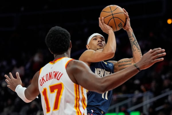 New Orleans Pelicans guard Brandon Boston Jr. (11) shoots against Atlanta Hawks forward Onyeka Okongwu (17) during the first half of an NBA basketball game, Monday, Dec. 2, 2024, in Atlanta. (AP Photo/Mike Stewart)