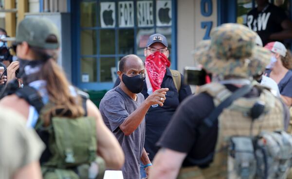 8/15/20 - Stone Mountain, GA - Protestors and counter protestors face off in the town of Stone Mountain after Stone Mountain Park was closed.  Several far-right groups, including militias and white supremacists, were planning to rally Saturday at Stone Mountain, and a broad coalition of leftist anti-racist groups are organizing a counter-demonstration. Local authorities, who have been closely monitoring online chatter about the rally, are bracing for possible conflict.   Jenni Girtman for the Atlanta Journal Constitution