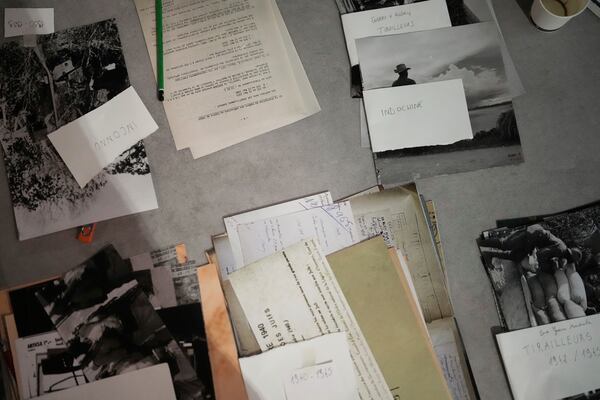 Archival documents on a table as French artist Shuck One prepares a mural for the exhibition "Paris Noir", at the Centre Pompidou Museum, in Paris, Tuesday, Feb. 18, 2025. (AP Photo/Thibault Camus)