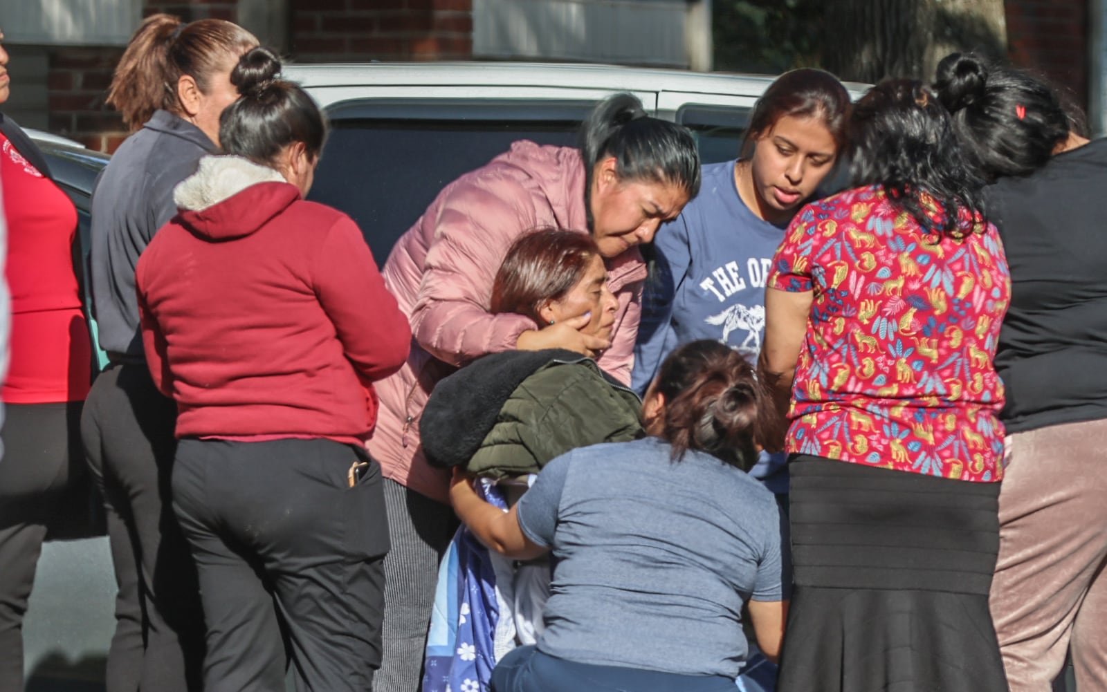 A woman grieves Monday as she learns the news that another woman was fatally shot at the Gwinnett Station Apartment Homes community.