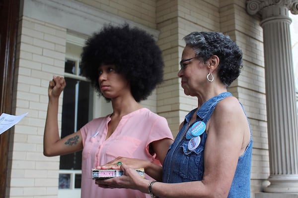 Mariah Parker is sworn in  as an Athens-Clarke County commissioner while putting her hand over "The Autobiography of Malcolm X." 