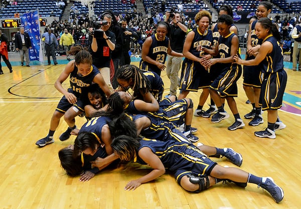 MARCH 6, 2014 MACON Kendrick Cherokees players celebrate their win on the court after the game. Coverage of the Class AA girls basketball championship between Wesleyan Wolves and Kendrick Cherokees at the Macon Coliseum Friday, March 7, 2014. Kendrick won, knocking off the Wesleyan Wolves, 69-58. KENT D. JOHNSON / KDJOHNSON@AJC.COM Kendrick Cherokees players celebrate their win on the court after defeating Wesleyan 69-58 for the Class AA girls state tile Friday, March 7, 2014, in Macon.