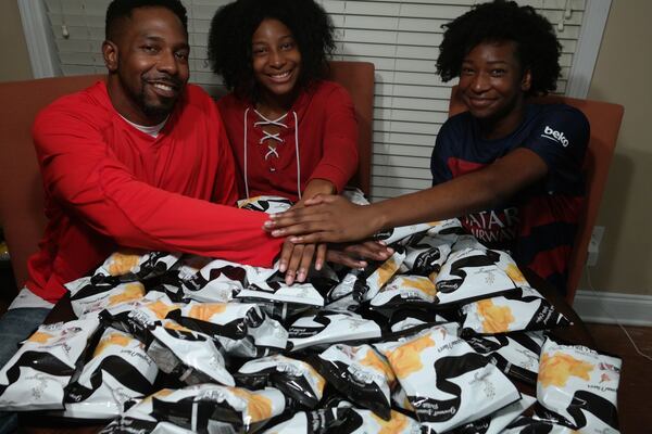 Dondre Anderson (left) and his two daughters, Amari (center) and Amina (right), are owners of one of the world’s few black-owned potato chip companies. CONTRIBUTED BY DONDRE ANDERSON