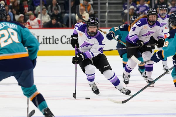 Minnesota defenseman Claire Thompson moves the puck up the ice during the second period of a PWHL game between the New York Sirens and the Minnesota Frost, at Little Caesars Arena, in Detroit, Sunday, March 16, 2025. (David Guralnick/Detroit News via AP)