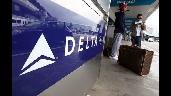 Delta Airlines customers wait to have their baggage checked at San Francisco International Airport. 